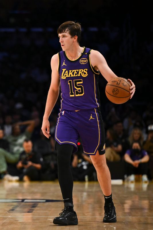 Oct 25, 2024; Los Angeles, California, USA; Los Angeles Lakers guard Austin Reaves (15) looks to pass against the Phoenix Suns during the first half at Crypto.com Arena. Mandatory Credit: Jonathan Hui-Imagn Images