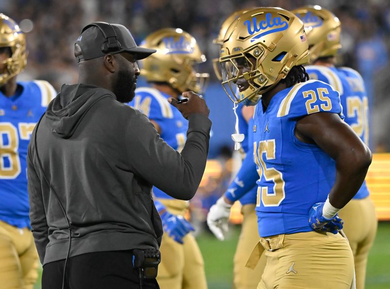 Sep 28, 2024; Pasadena, California, USA; UCLA Bruins head coach DeShaun Foster talks to Oregon Ducks at the Rose Bowl. Mandatory Credit: Robert Hanashiro-Imagn Images