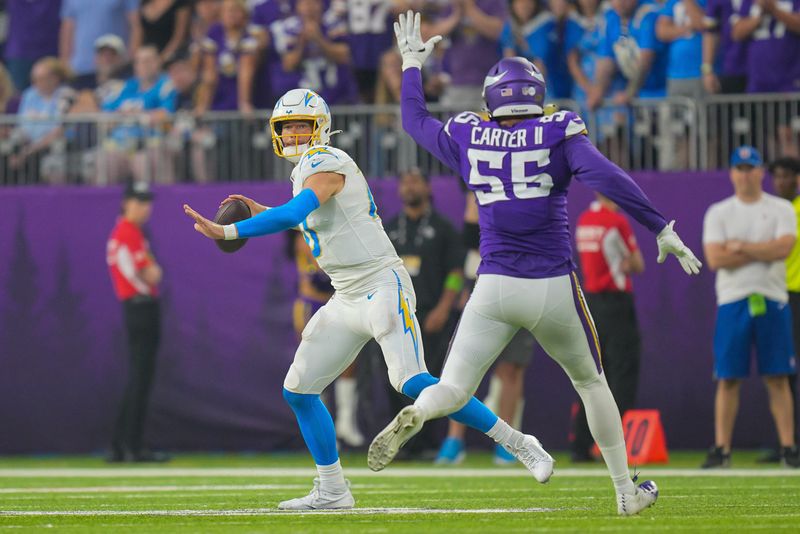 Sep 24, 2023; Minneapolis, Minnesota, USA; Los Angeles Chargers quarterback Justin Herbert (10) passes against the Minnesota Vikings center Garrett Bradbury (56) in the fourth quarter at U.S. Bank Stadium. Mandatory Credit: Brad Rempel-USA TODAY Sports