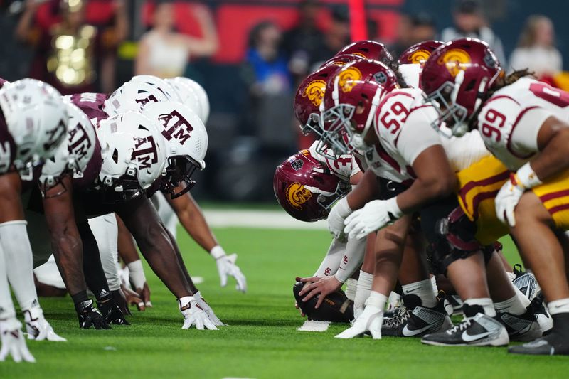 Dec 27, 2024; Las Vegas, NV, USA; Helmets at the line fo scrimmage as DUPLICATE***Southern California Trojans long snapper Hank Pepper (31) snaps the ball against the Texas A&M Aggies at Allegiant Stadium. Mandatory Credit: Kirby Lee-Imagn Images