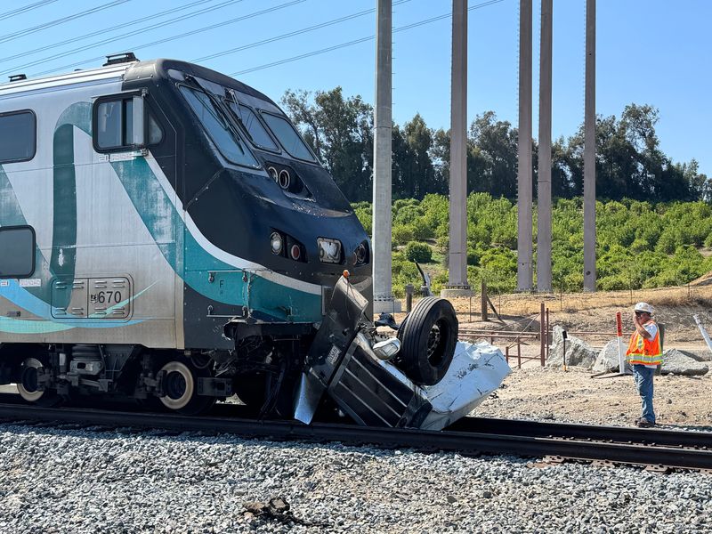 Rail personnel investigate a collision between a Metrolink train and semitrailer in Moorpark June 25, 2025, that killed the truck driver.