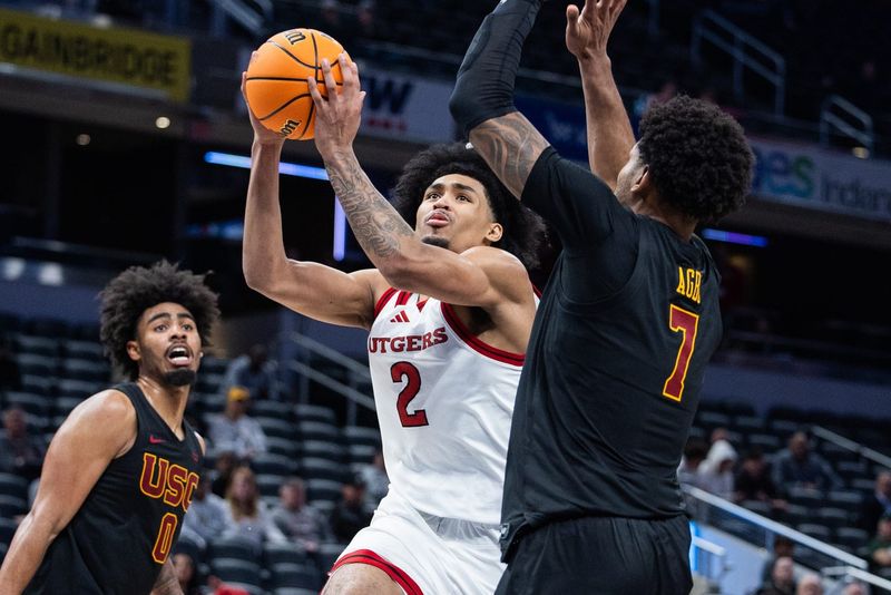 Mar 12, 2025; Indianapolis, IN, USA; Rutgers Scarlet Knights guard Dylan Harper (2) shoots the ball while USC Trojans guard Chibuzo Agbo (7) defends in the second half at Gainbridge Fieldhouse. Mandatory Credit: Trevor Ruszkowski-Imagn Images