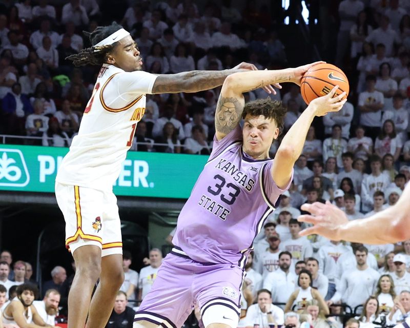 Feb 1, 2025; Ames, Iowa, USA; Kansas State Wildcats guard Coleman Hawkins (33) is defended by Iowa State Cyclones guard Keshon Gilbert (10) during the second half at James H. Hilton Coliseum. Mandatory Credit: Reese Strickland-Imagn Images