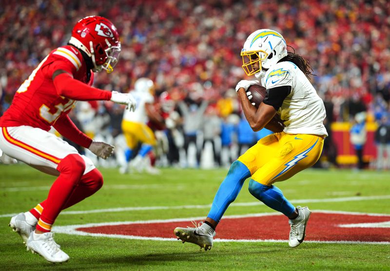 Dec 8, 2024; Kansas City, Missouri, USA; Los Angeles Chargers wide receiver Quentin Johnston (1) catches a touchdown pass against Kansas City Chiefs cornerback Keith Taylor Jr. (39) during the second half at GEHA Field at Arrowhead Stadium. Mandatory Credit: Jay Biggerstaff-Imagn Images