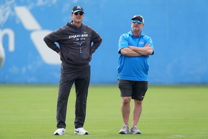 May 12, 2025; El Segundo, CA, USA; Los Angeles Chargers coach Jim Harbaugh (left) and general manager Joe Hortiz watch during offseason workouts at The Bolt. Mandatory Credit: Kirby Lee-Imagn Images