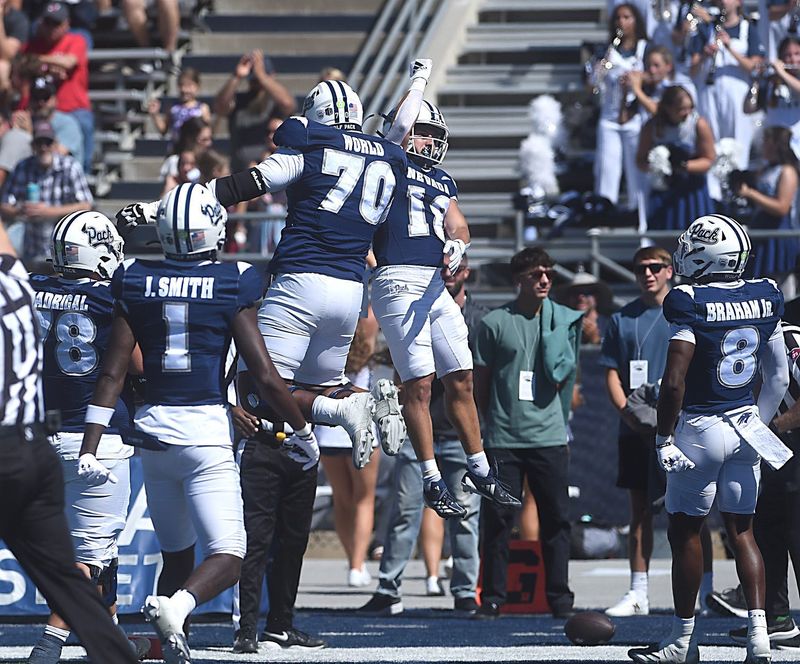 Nevadaâ€™s Marcus Bellon (18) and Isaiah World celebrate a touchdown while taking on Eastern Washington during their football game at Mackay Stadium in Reno on Sept. 21, 2024.