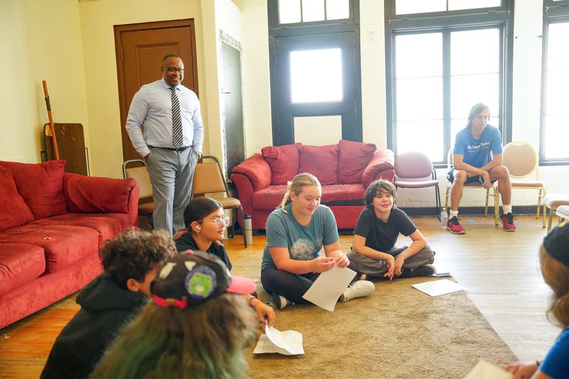 Palm Springs Unified School District Superintendent Dr. Marcus Funchess, left, observes children in the Palm Canyon Theatre Kids Camp on his first day on the job in Palm Springs, Calif., July 1, 2025.