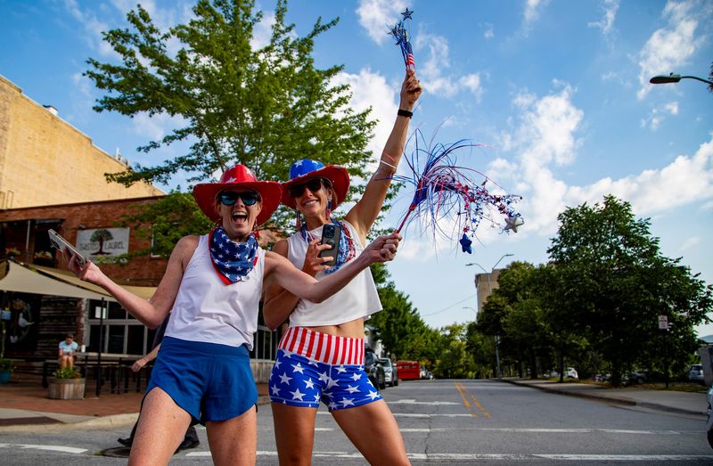 Asheville residents cheer as runners make their way along College Street in downtown Asheville during the 2025 Asheville Independence Day 5K, July 4, 2025.
