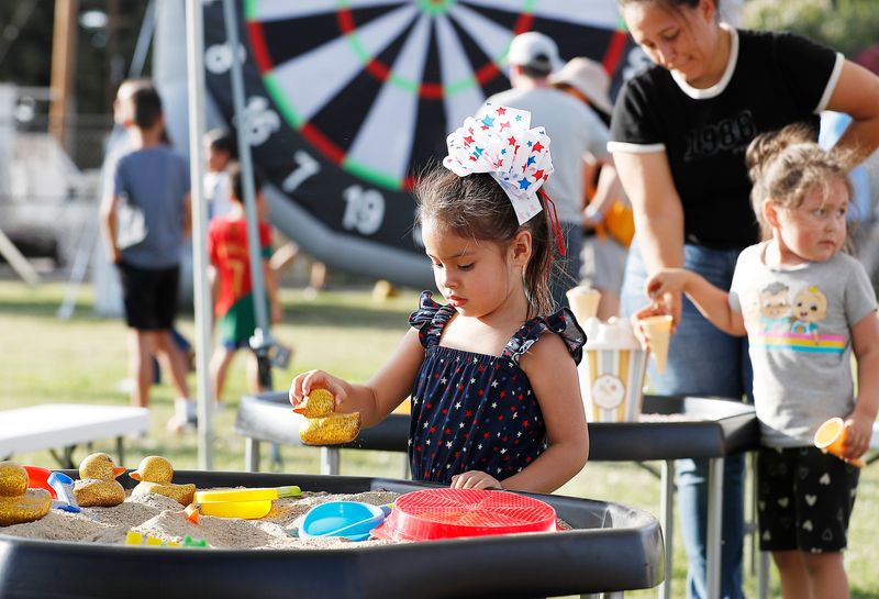 Rhea Salazar plays in the sand during the city's 2nd Annual Independence Spectacular, which was a free, family-friendly celebration packed with live entertainment, food, music, a kids’ zone, and drone light show at Riverway Sport Park on Thursday, July 5, 2025 in Visalia, Calif.