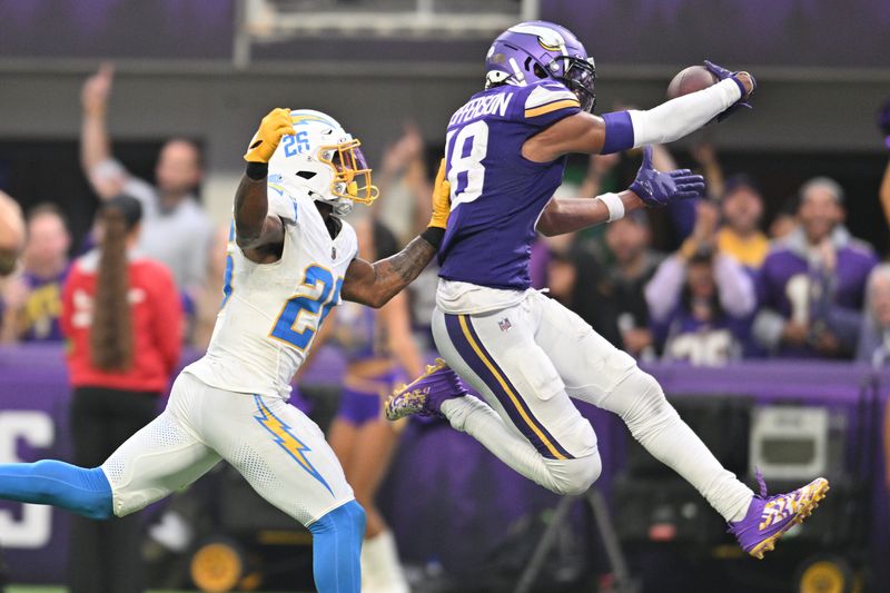 Minnesota Vikings wide receiver Justin Jefferson (18) scores on a touchdown pass as Los Angeles Chargers cornerback Asante Samuel Jr. (26) chases from behind during the fourth quarter at U.S. Bank Stadium. Mandatory Credit: Jeffrey Becker-USA TODAY Sports