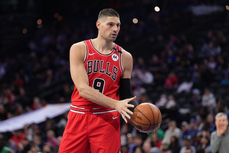 Apr 13, 2025; Philadelphia, Pennsylvania, USA; Chicago Bulls center Nikola Vucevic (9) receives a pass against the Philadelphia 76ers in the first quarter at Wells Fargo Center. Mandatory Credit: Kyle Ross-Imagn Images
