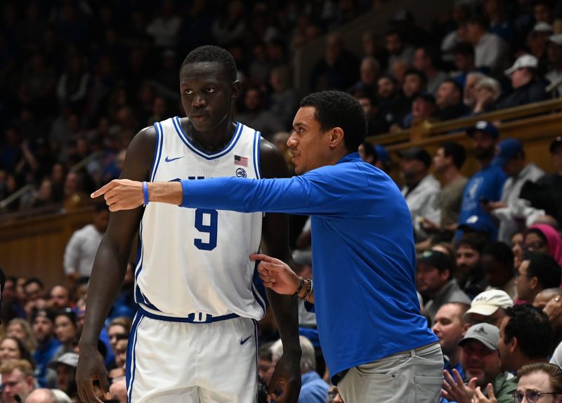 Dec 10, 2024; Durham, North Carolina, USA; Duke Blue Devils Director of player development, Justin Robinson (right) directs center Khaman Maluach (9) during the second half against the Incarnate Word Cardinals at Cameron Indoor Stadium. Mandatory Credit: Rob Kinnan-Imagn Images