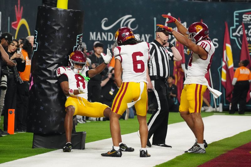 Dec 27, 2024; Las Vegas, NV, USA; Southern California Trojans wide receiver Ja'Kobi Lane (8) celebrates with wide receiver Makai Lemon (6) and wide receiver Kyle Ford (81) after scoring on a 15-yard touchdown run against the Texas A&M Aggies in the fourth quarter at Allegiant Stadium. Mandatory Credit: Kirby Lee-Imagn Images