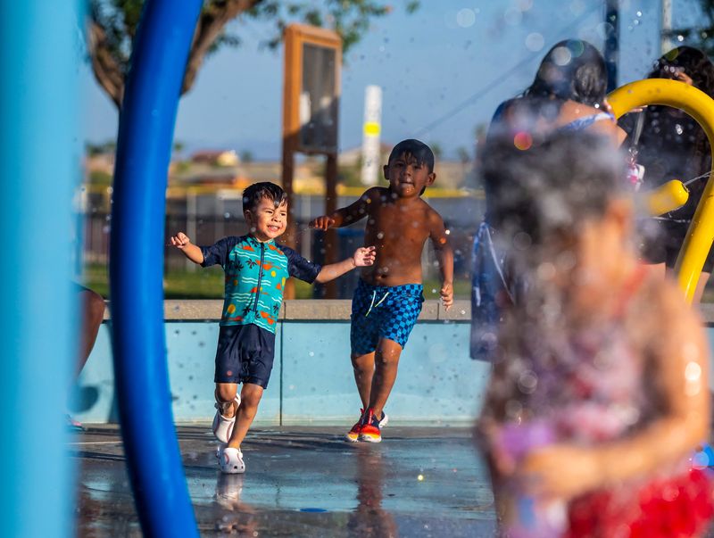4-year-old Ricky chases after 2-year-old Tony Rodriguez among the fountains at La Quinta Park in La Quinta, Calif., Tuesday, July 8, 2025.