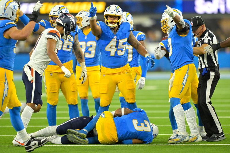 Dec 19, 2024; Inglewood, California, USA; Los Angeles Chargers linebacker Tuli Tuipulotu (45) signals after a fumble recovery against the Denver Broncos at SoFi Stadium. Mandatory Credit: Jayne Kamin-Oncea-Imagn Images