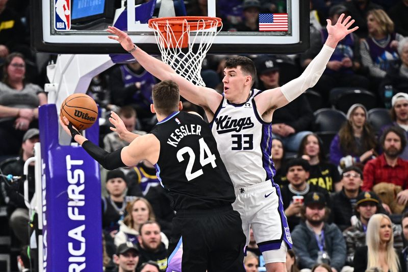 Feb 26, 2025; Salt Lake City, Utah, USA; Sacramento Kings forward Jake LaRavia (33) fouls Utah Jazz center Walker Kessler (24) in the first half at Delta Center. Mandatory Credit: Jamie Sabau-Imagn Images