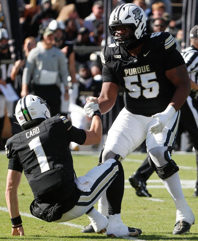 Purdue Boilermakers offensive lineman DJ Wingfield (55) helps up Purdue Boilermakers quarterback Hudson Card (1) Saturday, Nov. 2, 2024, during the NCAA football game against the Northwestern Wildcats at Ross-Ade Stadium in West Lafayette, Ind. Northwestern Wildcats won 26-20.