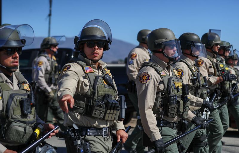 Ventura County Sheriff's deputies marched into the intersection of Laguna and Wood roads, forcing a crowd of around 50 demonstrators to disperse in order to allow vehicles to access the immigration raid taking place outside Camarillo July 10, 2025.