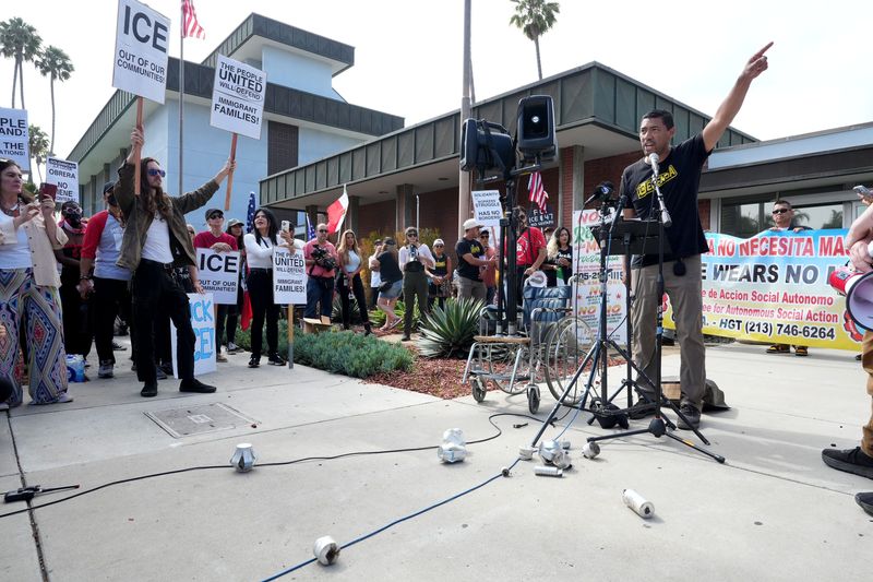 Leo Martinez with the organization VC Defensa talks about his experience with tear gas and rubber bullets, which he drops on the ground while speaking to hundreds of people at Oxnard City Hall on July 11, 2025, during a protest against immigration raids that took place the day before at a farm near Camarillo.
