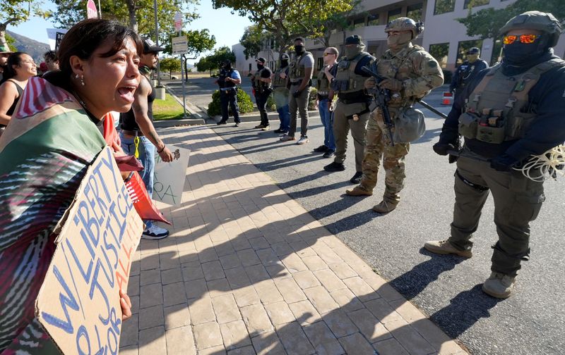 Monica Montoya of Oxnard protests and cries at the sight of armed federal immigration agents as she joins a large group outside a U.S. Immigration and Customs Enforcement field office in Camarillo on July 14, 2025. Demonstrators railed against immigration enforcement actions, including the July 10 raid at Glass House Farms near Camarillo.