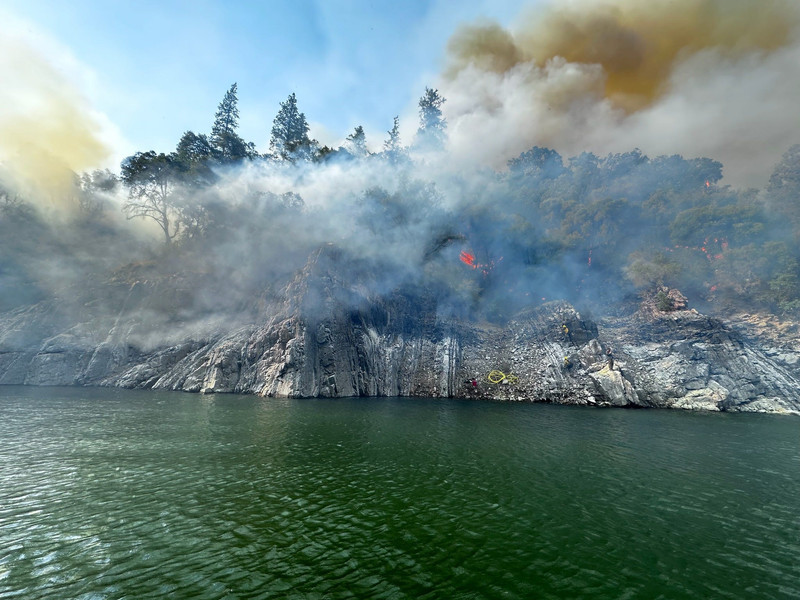 Firefighters extinguished a 50-acre spot fire, ignited on Monday, July 14, 2025, by the Green Fire near the Sulanharas arm of Shasta Lake in the Shasta-Trinity National Forest.
