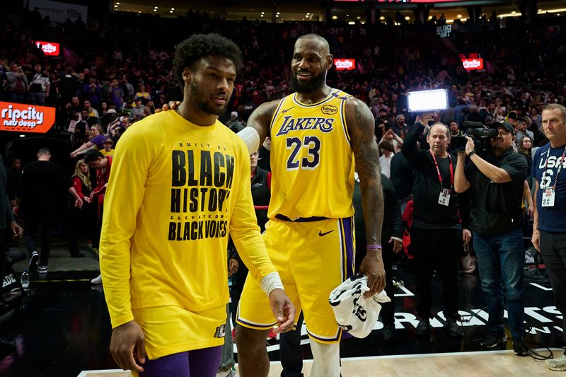 Feb 20, 2025; Portland, Oregon, USA; Los Angeles Lakers forward LeBron James (23) celebrates victory over the Portland Trail Blazers with his son guard Bronny James (9) at Moda Center. Mandatory Credit: Troy Wayrynen-Imagn Images