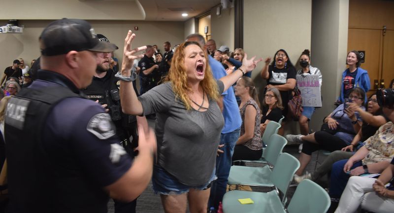 Police respond to outbursts at the Simi Valley City Council meeting on July 21. Moments later, Mayor Dee Dee Cavanaugh cleared the council chambers, then reopened them. No arrests were made.