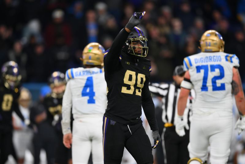 Nov 15, 2024; Seattle, Washington, USA; Washington Huskies defensive lineman Russell Davis II (99) celebrates after sacking UCLA Bruins quarterback Ethan Garbers (4) during the second half at Alaska Airlines Field at Husky Stadium. Mandatory Credit: Steven Bisig-Imagn Images