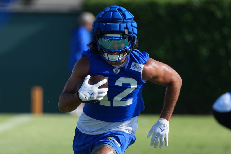 Jul 23, 2025; Los Angeles, CA, USA; Los Angeles Rams receiver Puka Nacua (12) carries the ball during training camp at Loyola Marymount University. Mandatory Credit: Kirby Lee-Imagn Images
