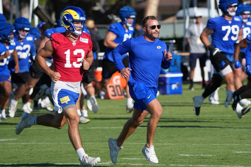 Jul 23, 2025; Los Angeles, CA, USA; Los Angeles Rams coach Sean McVay runs with quarterback Stetson Bennett (13) during training camp at Loyola Marymount University. Mandatory Credit: Kirby Lee-Imagn Images