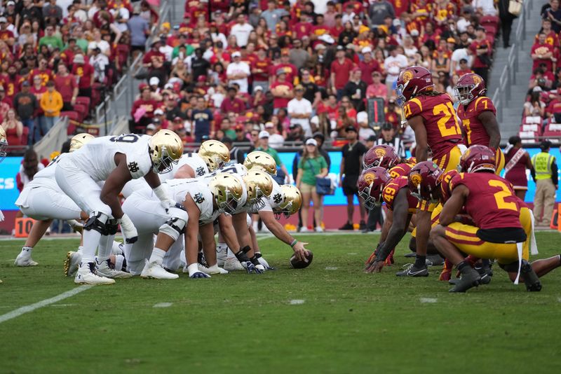 Nov 30, 2024; Los Angeles, California, USA; Helmets at the line of scrimmage as Notre Dame Fighting Irish long snapper Rino Monteforte (39) snaps the ball against the Southern California Trojans at United Airlines Field at Los Angeles Memorial Coliseum. Mandatory Credit: Kirby Lee-Imagn Images