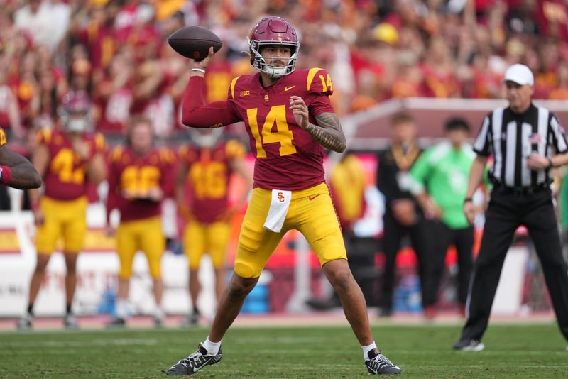 Nov 30, 2024; Los Angeles, California, USA; Southern California Trojans quarterback Jayden Maiava (14) throws the ball against the Notre Dame Fighting Irish in the first half at United Airlines Field at Los Angeles Memorial Coliseum. Mandatory Credit: Kirby Lee-Imagn Images