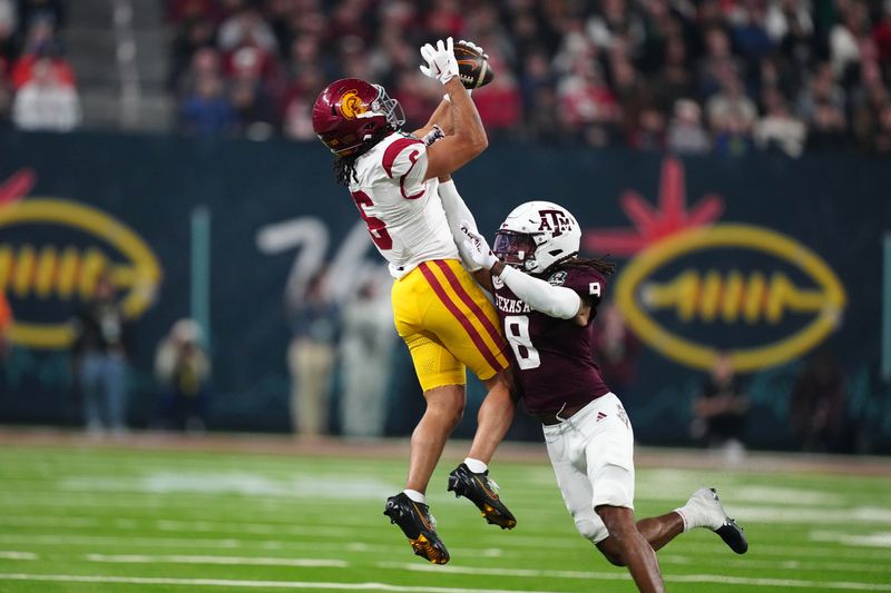 Dec 27, 2024; Las Vegas, NV, USA; Southern California Trojans wide receiver Makai Lemon (6) catches the ball against Texas A&M Aggies defensive back Jaydon Hill (8) in the second half at Allegiant Stadium. Mandatory Credit: Kirby Lee-Imagn Images