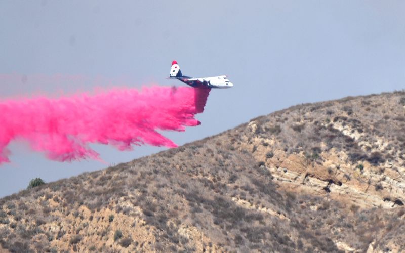 A plane drops retardant on the Canyon Fire, which started southeast of Lake Piru around 1:30 p.m. on Aug. 7, 2025, in a remote area in the mountains between Piru and Interstate 5.
