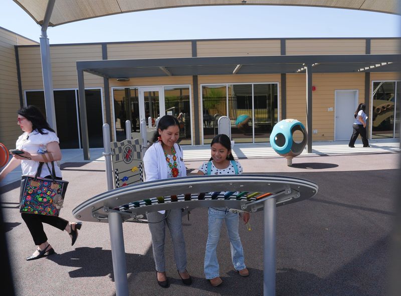 People check out the playground facilities at the opening of the new North Shore Elementary School in North Shore, Calif., August 11, 2025.