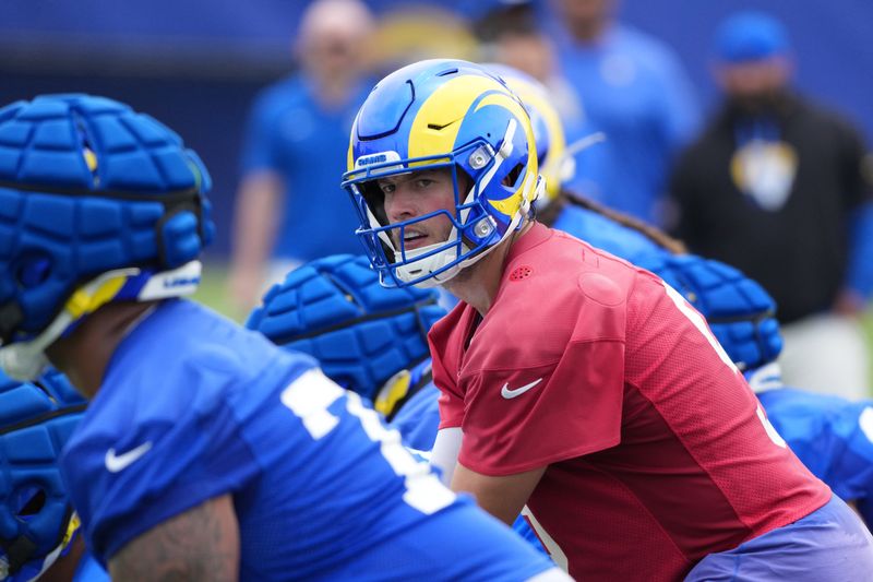 May 28, 2025; Woodland Hills, CA, USA; Los Angeles Rams quarterback Matthew Stafford (9) prepares to take the snap during organized team activities at Rams Practice Facility. Mandatory Credit: Kirby Lee-Imagn Images