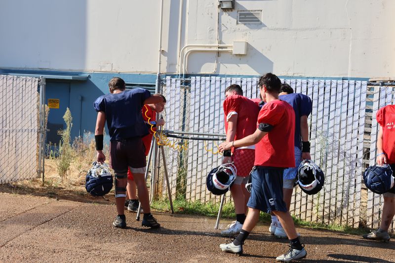Central Valley football players hit the water station during a break at practice on Monday, Aug. 11, 2025.