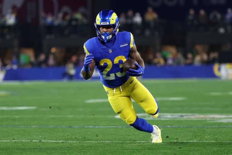 Jan 13, 2025; Glendale, AZ, USA; Los Angeles Rams running back Kyren Williams (23) rushes the ball against the Minnesota Vikings during the first half in an NFC wild card game at State Farm Stadium. Mandatory Credit: Mark J. Rebilas-Imagn Images