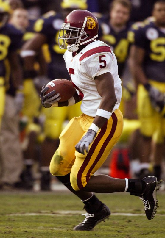 Jan 1, 2004; Pasadena, CA, USA: FILE PHOTO; Southern California Trojans running back Reggie Bush (5) in action against the Michigan Wolverines during the 2004 Rose Bowl at the Rose Bowl. The Trojans defeated the Wolverines 28-14. Mandatory Credit: Richard Mackson-USA TODAY Network