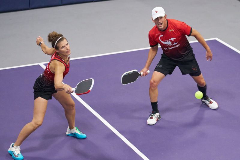 Members of the Coachella Valley Scorpions, Stacy Zelenski (left) and Keith Jain, react to the pickleball during a competition in Austin, Texas on Aug. 12, 2025.