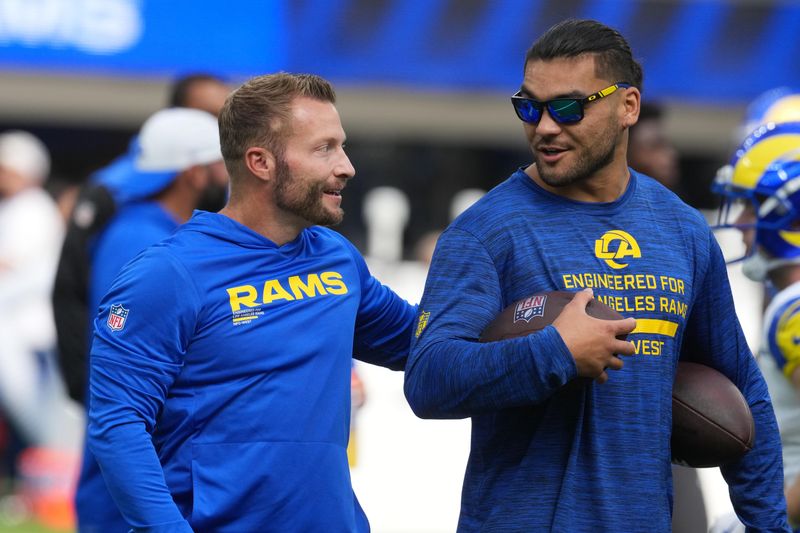 Aug 16, 2025; Inglewood, California, USA; Los Angeles Rams coach Sean McVay (left) talks with wide receiver Puka Nacua (12) against the Los Angeles Chargers in the first half at SoFi Stadium. Mandatory Credit: Kirby Lee-Imagn Images