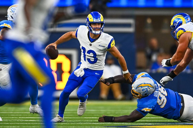 Aug 16, 2025; Inglewood, California, USA; Los Angeles Rams quarterback Stetson Bennett IV (13) looks to pass the ball against the Los Angeles Chargers during the fourth quarter at SoFi Stadium. Mandatory Credit: Jonathan Hui-Imagn Images
