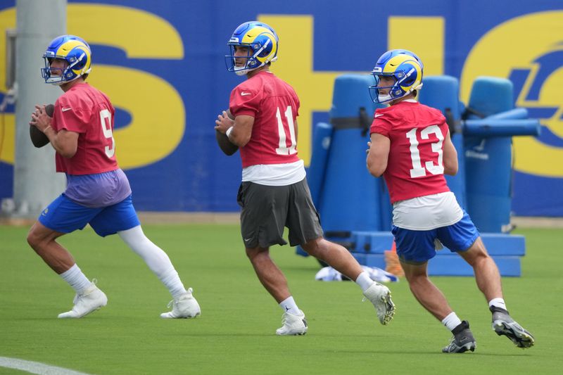 May 28, 2025; Woodland Hills, CA, USA; Los Angeles Rams quarterbacks Stetson Bennett (13) Jimmy Garoppolo (11) and Matt Stafford (9) participate in offensive drills during organized team activities at Rams Practice Facility. Mandatory Credit: Kirby Lee-Imagn Images