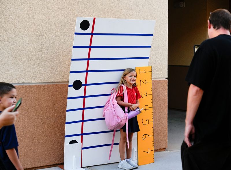 Students take photos before the start of the first day of school at George Washington Charter School in Palm Desert, Calif., August 20, 2025.