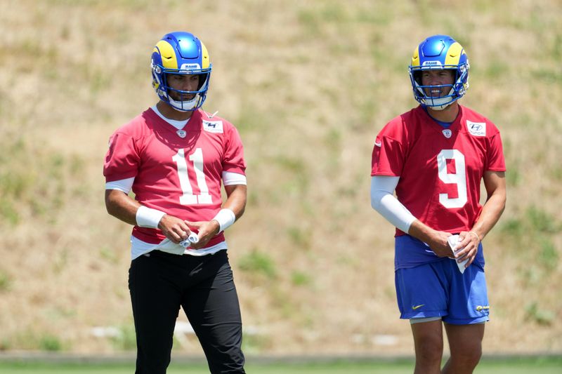 May 21, 2024, Thousand Oaks, California, USA; Los Angeles Rams quarterback Jimmy Garoppolo (11) and quarterback Matthew Stafford (9) during organized team activities at Cal Lutheran University. Mandatory Credit: Kirby Lee-USA TODAY Sports