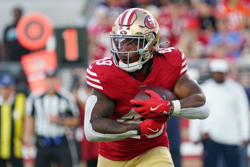 Aug 9, 2025; Santa Clara, California, USA; San Francisco 49ers running back Corey Kiner (49) runs the ball in the second quarter against Denver Broncos at Levi's Stadium. Mandatory Credit: David Gonzales-Imagn Images