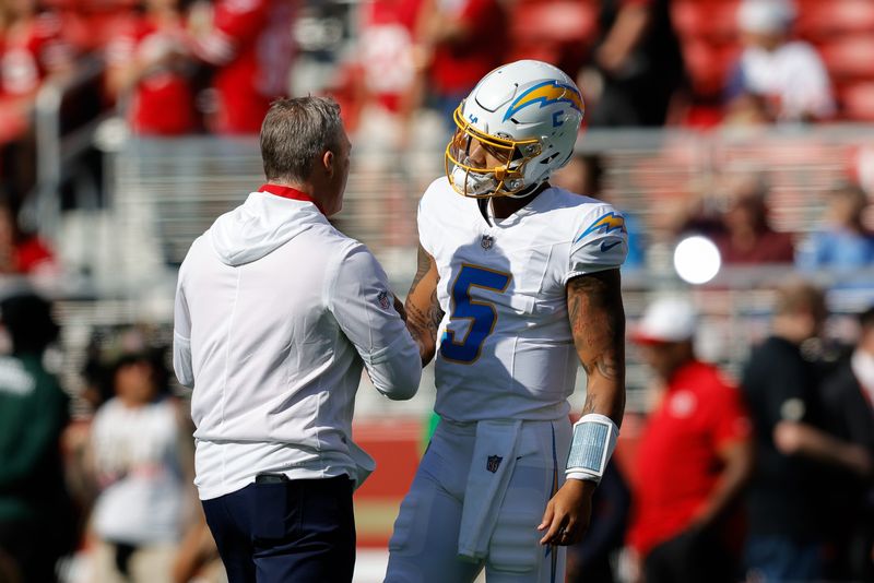 Aug 23, 2025; Santa Clara, California, USA; San Francisco 49ers general manager John Lynch shakes hands with Los Angeles Chargers quarterback Trey Lance (5) before a game at Levi's Stadium. Mandatory Credit: Sergio Estrada-Imagn Images