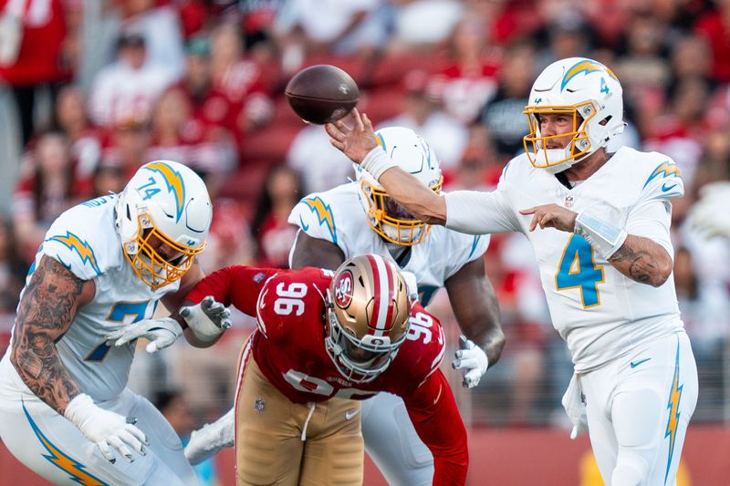 August 23, 2025; Santa Clara, California, USA; Los Angeles Chargers quarterback Taylor Heinicke (4) passes the football against San Francisco 49ers defensive end Jonathan Garvin (96) during the second quarter at Levi's Stadium. Mandatory Credit: Kyle Terada-Imagn Images
