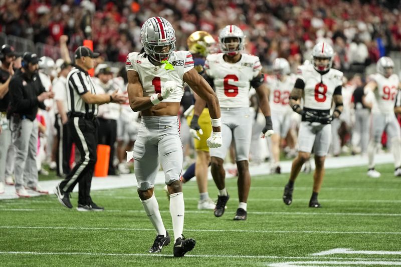 Ohio State Buckeyes cornerback Davison Igbinosun (1) celebrates a stop during the College Football Playoff National Championship against the Notre Dame Fighting Irish at Mercedes-Benz Stadium in Atlanta on Jan. 22, 2025.