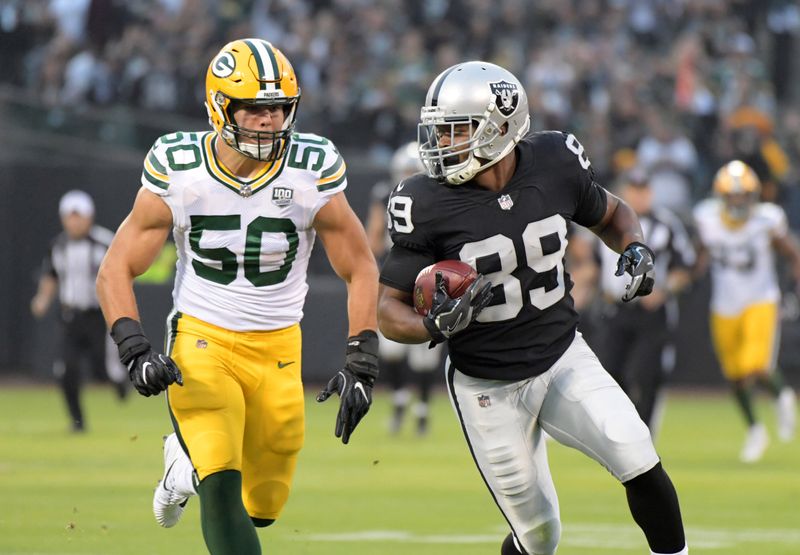 Aug 24, 2018; Oakland, CA, USA; Oakland Raiders wide receiver Amari Cooper (89) is pursued by Green Bay Packers linebacker Blake Martinez (50) in the first quarter during a preseason game at Oakland-Alameda County Coliseum.